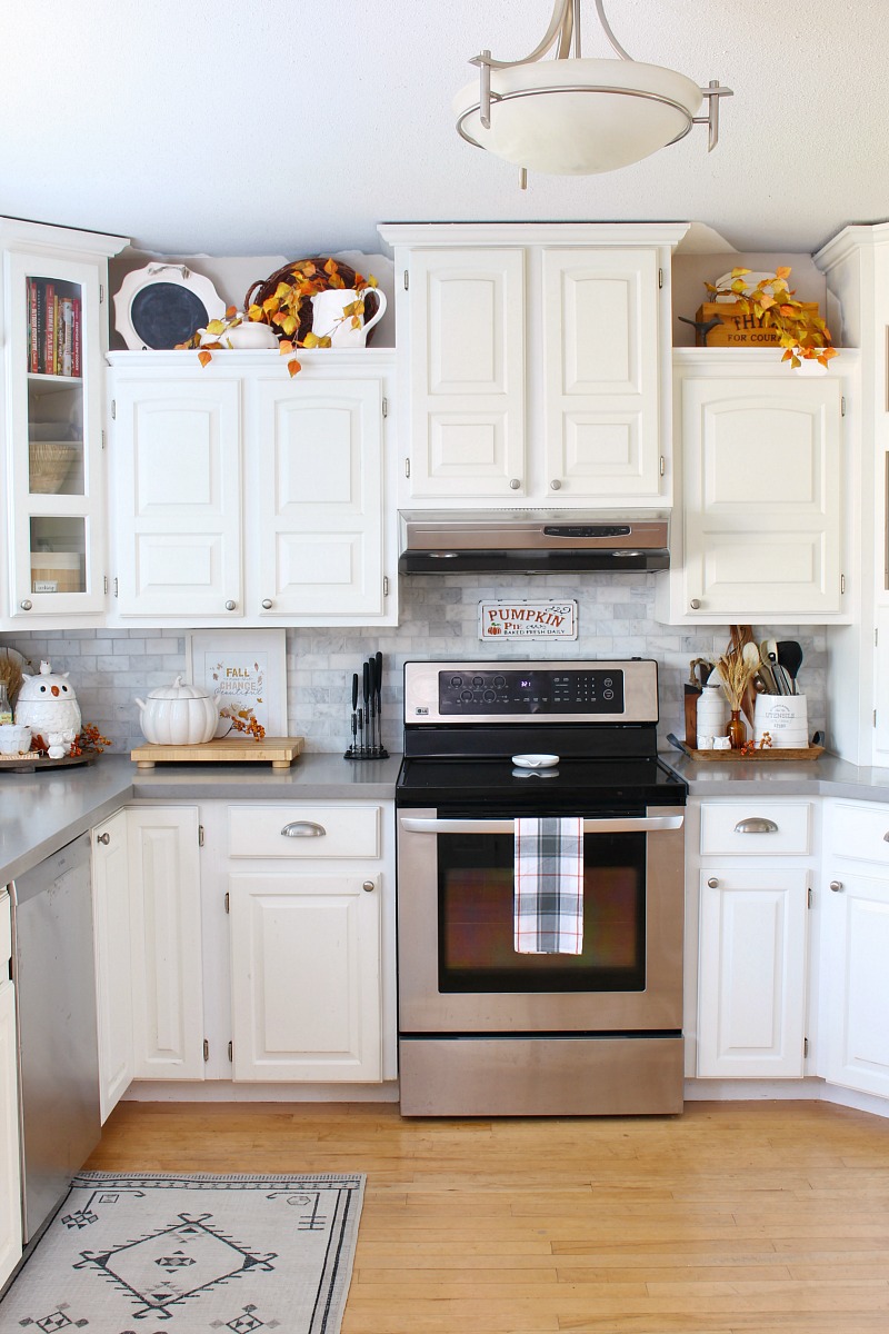 22 Style Tips for Decorating the Space Above Kitchen Cabinets Like a Pro (Don't Miss #11!) - 18. Use Decorative Plates
